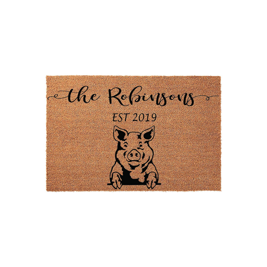 Personalized Pig Farmhouse Doormat featuring a cute pig illustration, custom family name, and established year printed in black ink on a natural coir fiber mat, creating a charming entryway decor piece for any country home or