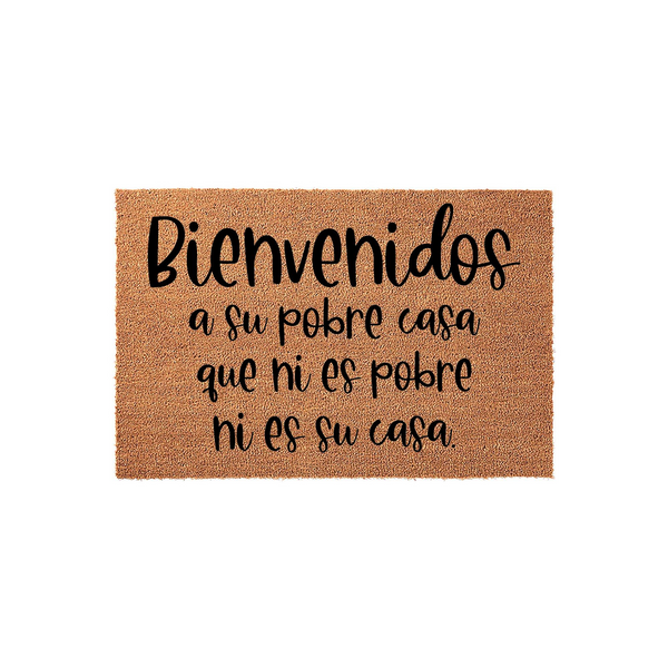 Funny Spanish doormat featuring the text Bienvenidos a su pobre casa que ni es pobre ni es su casa printed in black script on a natural tan coir fiber mat, creating a humorous and welcoming entrance for any home or apartment