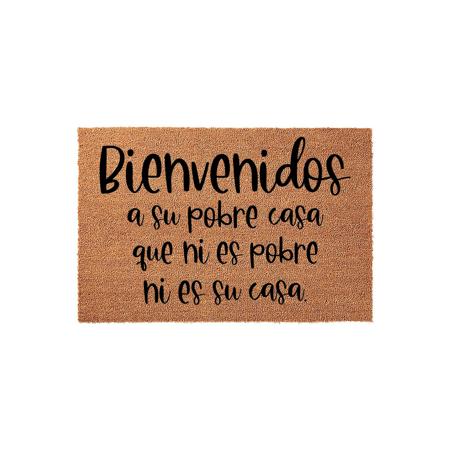 Funny Spanish doormat featuring the text Bienvenidos a su pobre casa que ni es pobre ni es su casa printed in black script on a natural tan coir fiber mat, creating a humorous and welcoming entrance for any home or apartment