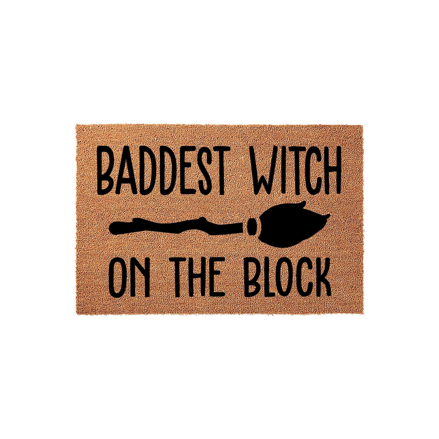 Baddest Witch on the Block Halloween doormat featuring a natural coir texture with bold black text and a witch broomstick graphic centered on the mat, perfect for adding a fun and spooky touch to your front porch decor this