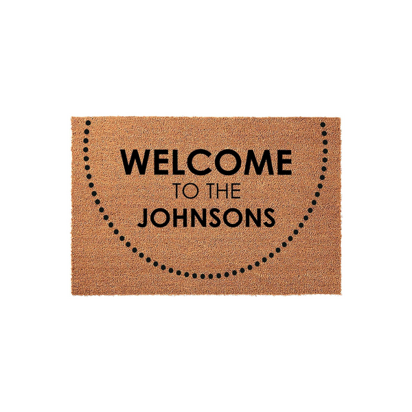 Personalized family name coir doormat featuring a minimalist dotted semi-circle design and the text Welcome to the Johnsons printed in bold black lettering, set against a clean white background for a modern home entryway