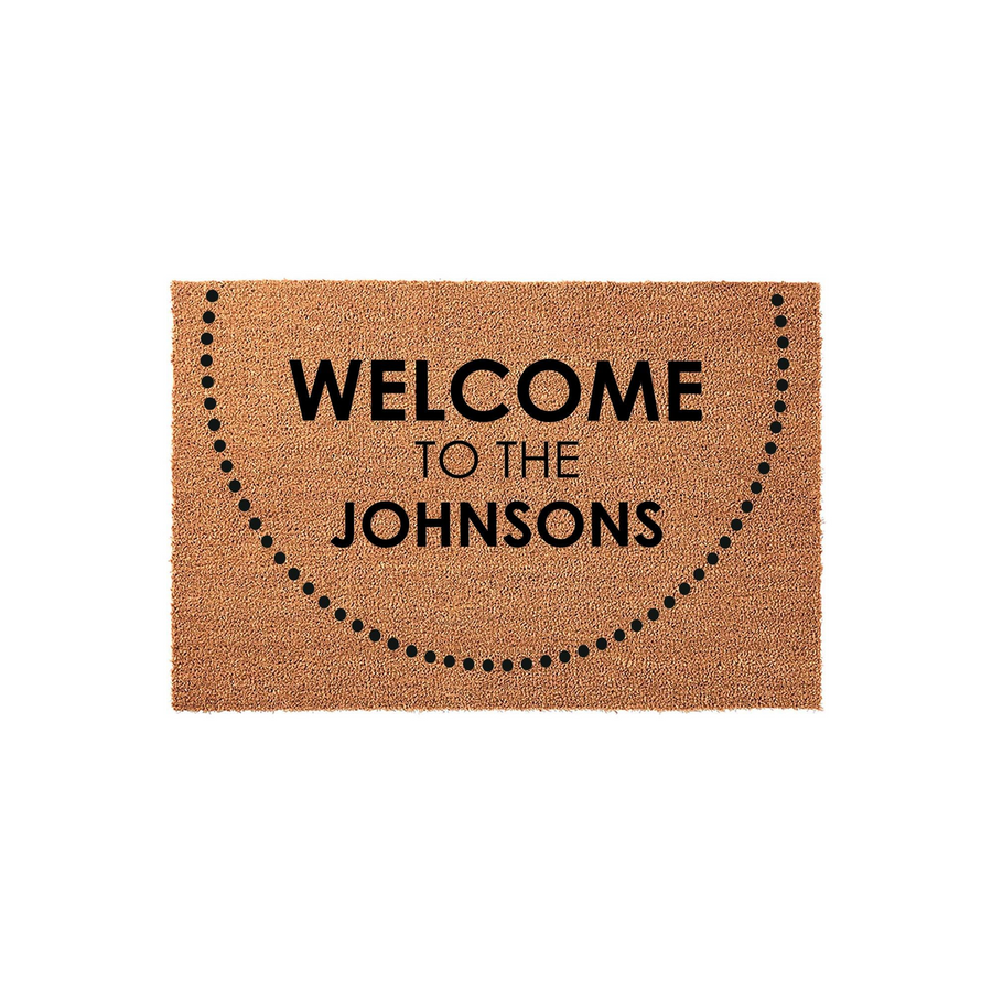 Personalized family name coir doormat featuring a minimalist dotted semi-circle design and the text Welcome to the Johnsons printed in bold black lettering, set against a clean white background for a modern home entryway