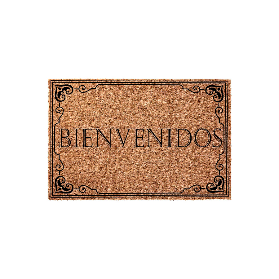Bienvenidos coir doormat featuring a natural brown coconut fiber texture and a decorative black border with elegant scrollwork, centered on a plain white background to highlight the welcoming Spanish text for a front porch
