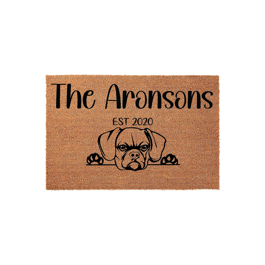 Personalized Boxer dog doormat featuring a cute illustration of a Boxer peeking over the bottom edge, with custom family name text and established year printed in black on a natural tan coir fiber background for a welcoming home