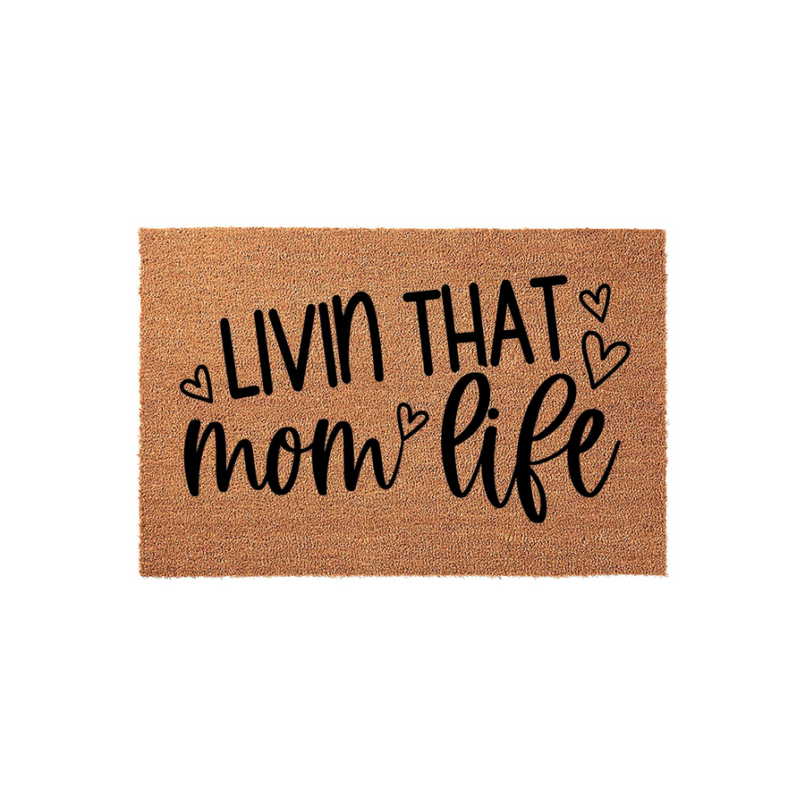 Livin That Mom Life coir doormat featuring a natural brown fiber texture and bold black lettering with decorative heart accents, creating a stylish and welcoming entryway decor piece for any home front porch or apartment door