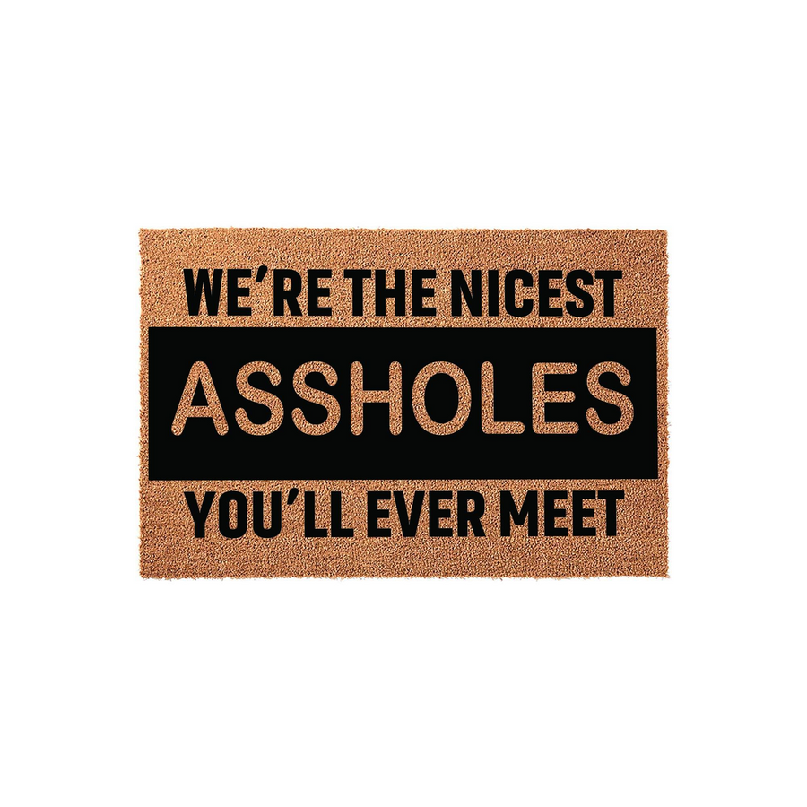 Funny doormat featuring a natural coir texture with bold black text that reads We are the nicest assholes you will ever meet, providing a humorous and welcoming touch to any front porch or entryway decor for guests to see upon