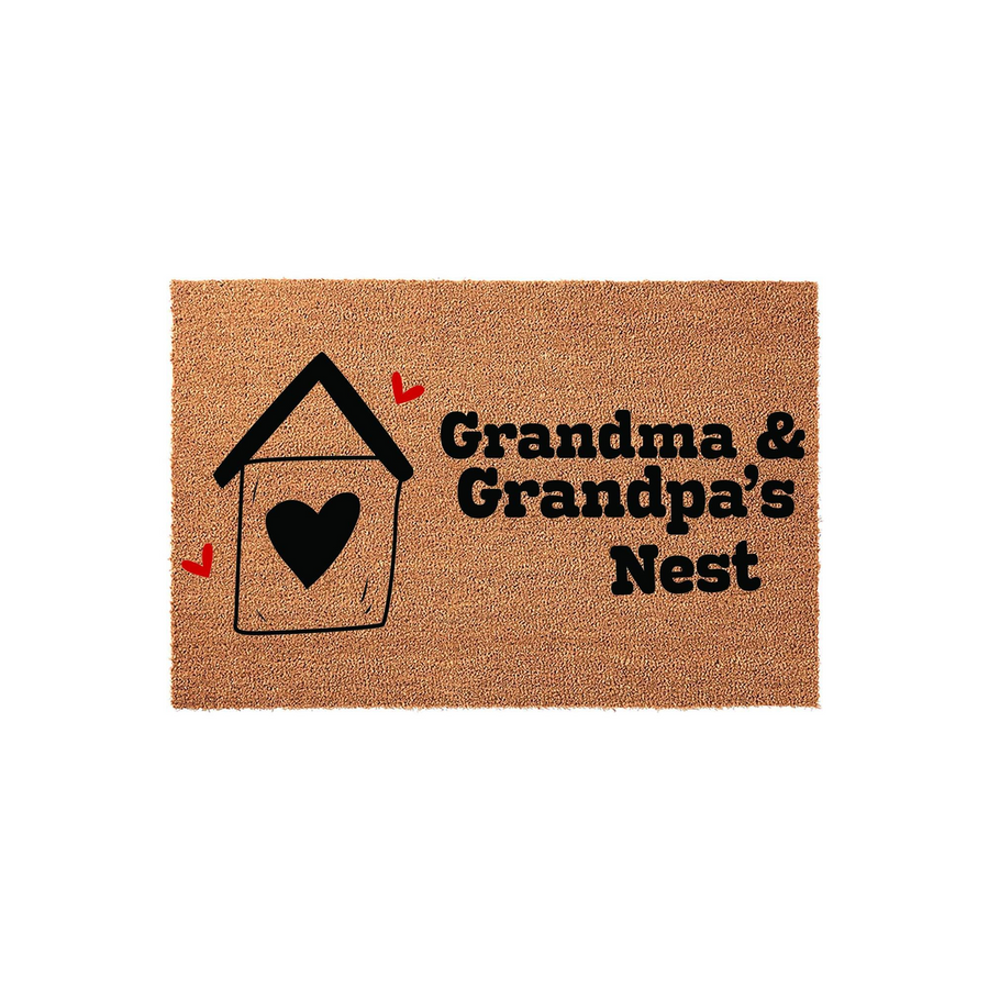 Grandma & Grandpa's Nest coir doormat featuring a black line-art house icon with a heart center and small red heart accents, providing a warm and welcoming entrance decor piece for a grandparent's home on a plain white background.