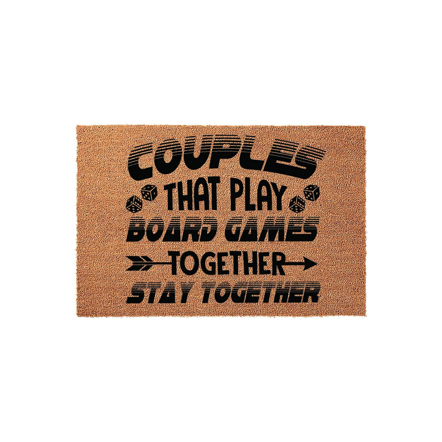 Couples That Play Board Games Together Stay Together coir doormat featuring black text and dice graphics on a natural brown fiber background, perfect for a fun entryway or a housewarming gift for gaming enthusiasts who love board