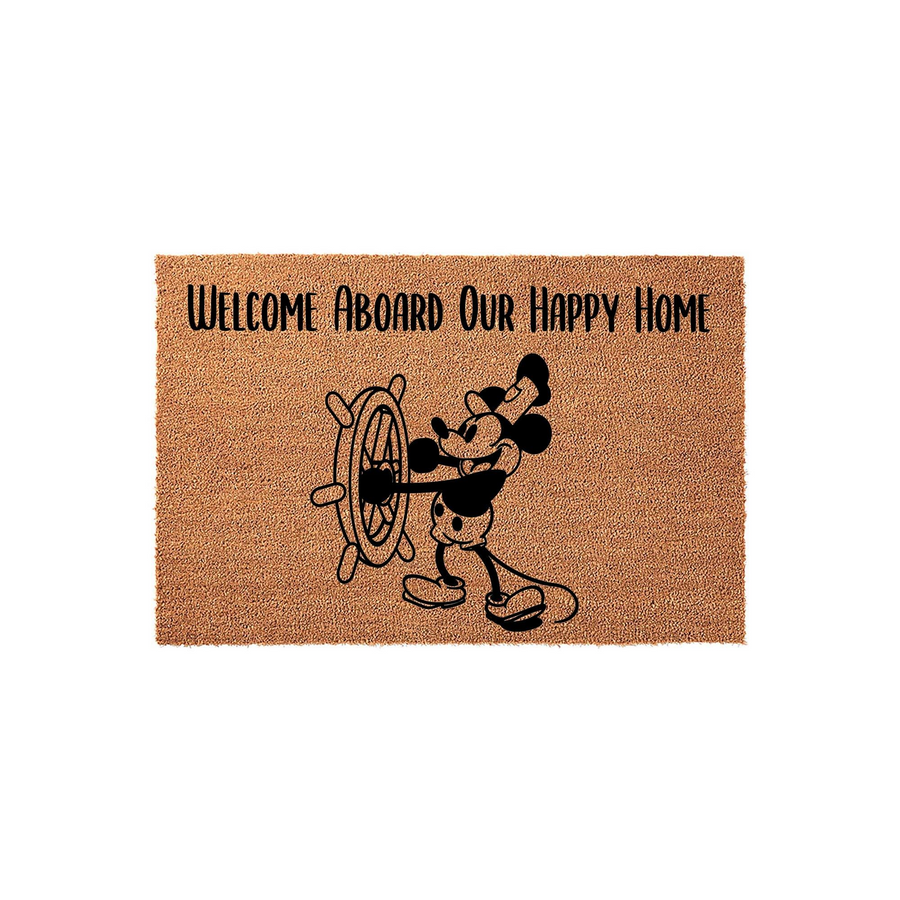 Mickey Mouse Welcome Aboard Our Happy Home coir doormat featuring a black silhouette of the iconic cartoon character steering a ship wheel, printed on a natural brown textured fiber mat for a fun and nautical entryway decor