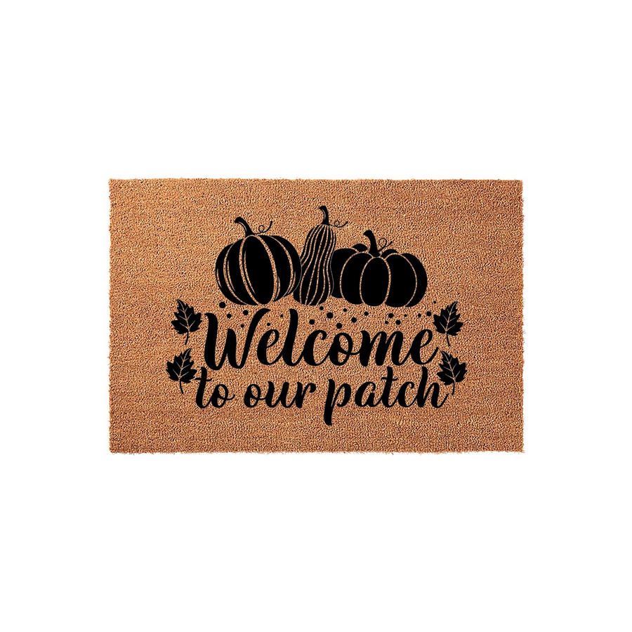 Fall Pumpkin Welcome To Our Patch Doormat featuring a natural coir texture with a black printed design of three pumpkins and autumn leaves, creating a festive seasonal entryway decor piece for your front porch or home entrance.