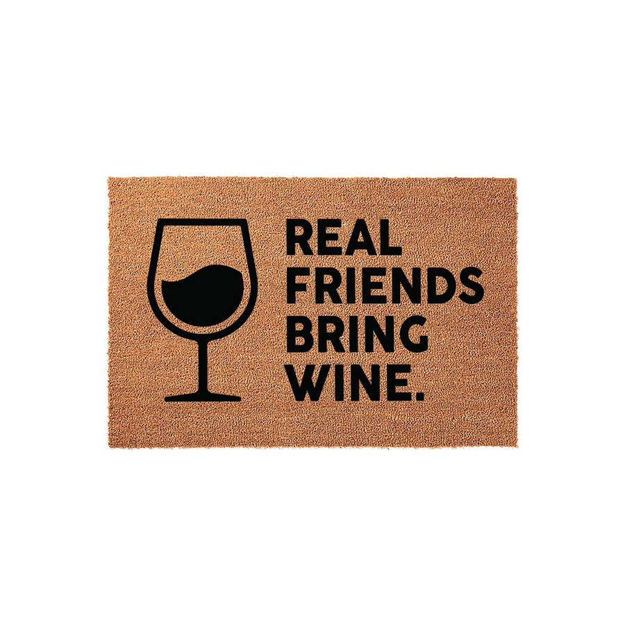 Real Friends Bring Wine coir doormat featuring a black graphic of a wine glass on the left side and bold text on the right, set against a natural tan textured fiber background for a fun and welcoming front porch entryway decor