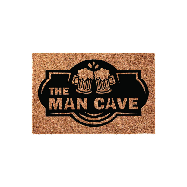 The Man Cave coir doormat features a bold black graphic of two clinking beer mugs above the text, set against a natural brown coconut fiber background that provides a durable and rustic look for any home entrance or basement game