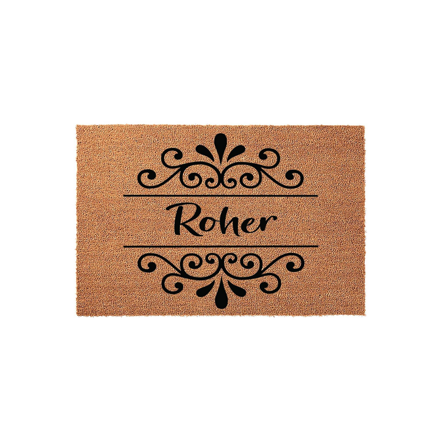 Personalized family name coir doormat featuring elegant black scrollwork flourishes above and below a custom last name, presented on a natural brown textured fiber background for a classic and welcoming front porch entryway decor.