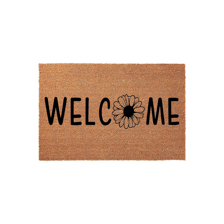 Floral Welcome Coir Doormat featuring a natural tan fiber texture with bold black lettering and a daisy flower replacing the letter O, creating a charming and rustic entryway accent for your front porch or home entrance decor.