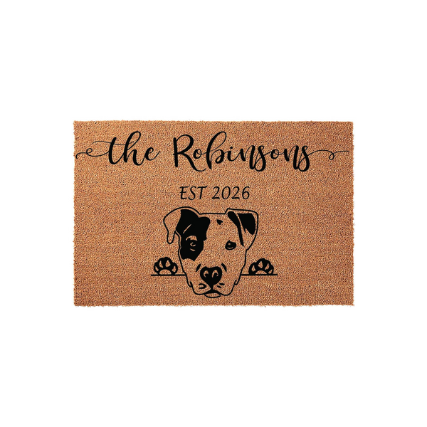 Personalized Pit Bull doormat featuring a cute dog illustration peeking over the edge, customized with a family name and established year on a natural coir fiber mat that adds a welcoming touch to any front porch or entryway