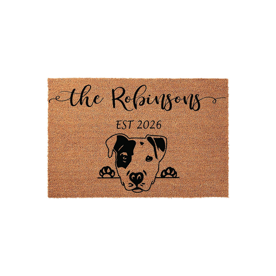 Personalized Pit Bull doormat featuring a cute dog illustration peeking over the edge, customized with a family name and established year on a natural coir fiber mat that adds a welcoming touch to any front porch or entryway