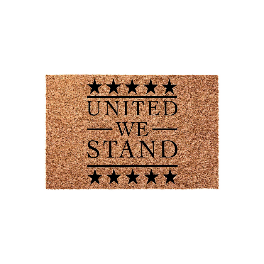 United We Stand coir doormat featuring a patriotic design with black stars and bold text on a natural brown fiber background, creating a durable and welcoming entrance mat for any home porch or front door entryway.