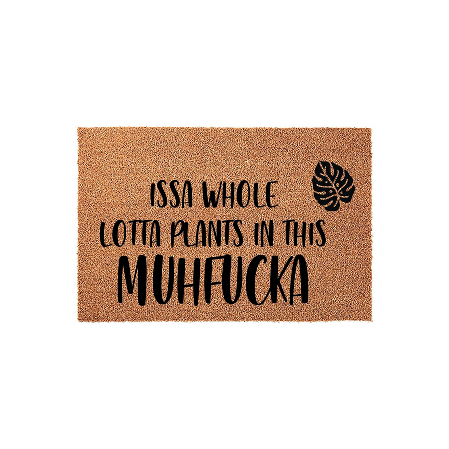 Funny Plant Lover Coir Doormat featuring a natural tan fiber texture and bold black text that reads Issa Whole Lotta Plants In This Muhfucka, accented with a single tropical monstera leaf graphic for a modern houseplant