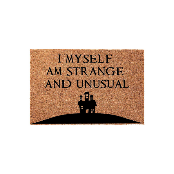 Strange and Unusual coir doormat featuring a spooky haunted house silhouette printed in black ink on a natural brown coconut fiber mat, perfect for adding a gothic or horror-themed touch to your front porch entryway decor.