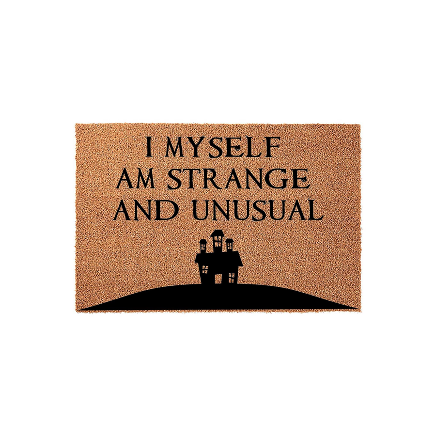 Strange and Unusual coir doormat featuring a spooky haunted house silhouette printed in black ink on a natural brown coconut fiber mat, perfect for adding a gothic or horror-themed touch to your front porch entryway decor.