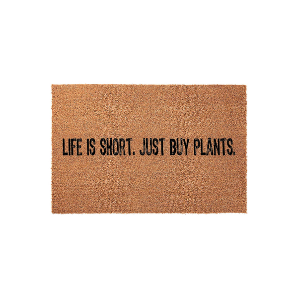 Life Is Short Just Buy Plants coir doormat featuring a natural brown fiber texture and bold black lettering, centered on a plain white background to showcase the humorous gardening quote for a front porch or entryway decor.