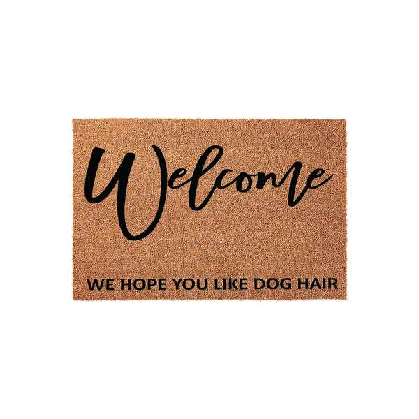 Funny Dog Hair Welcome Doormat featuring a natural coir texture with the word Welcome in a black script font and the humorous phrase We Hope You Like Dog Hair printed in a clean sans-serif font on a plain white studio background.