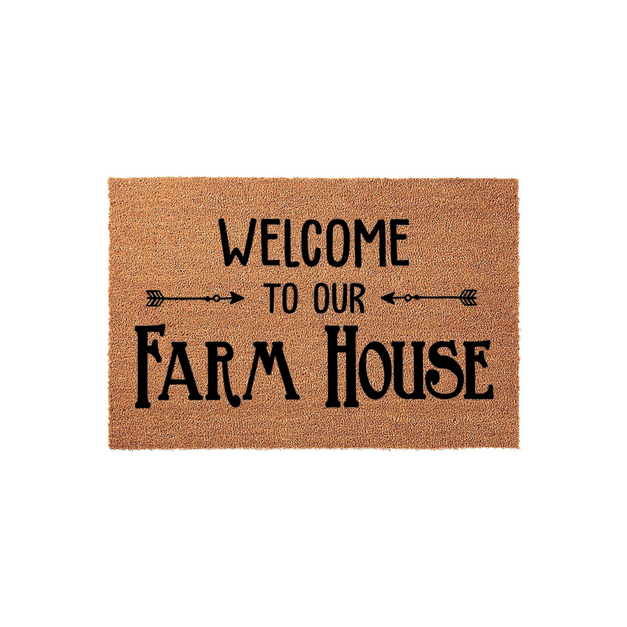 Farmhouse Welcome Doormat featuring a natural coir texture with black printed text that reads Welcome To Our Farm House, accented by decorative arrow graphics on a clean white background for a rustic entryway decor style.