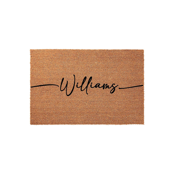 Personalized family name coir doormat featuring a natural tan fiber texture and elegant black script lettering centered across the middle, providing a durable and welcoming entrance decor piece for any front porch or home