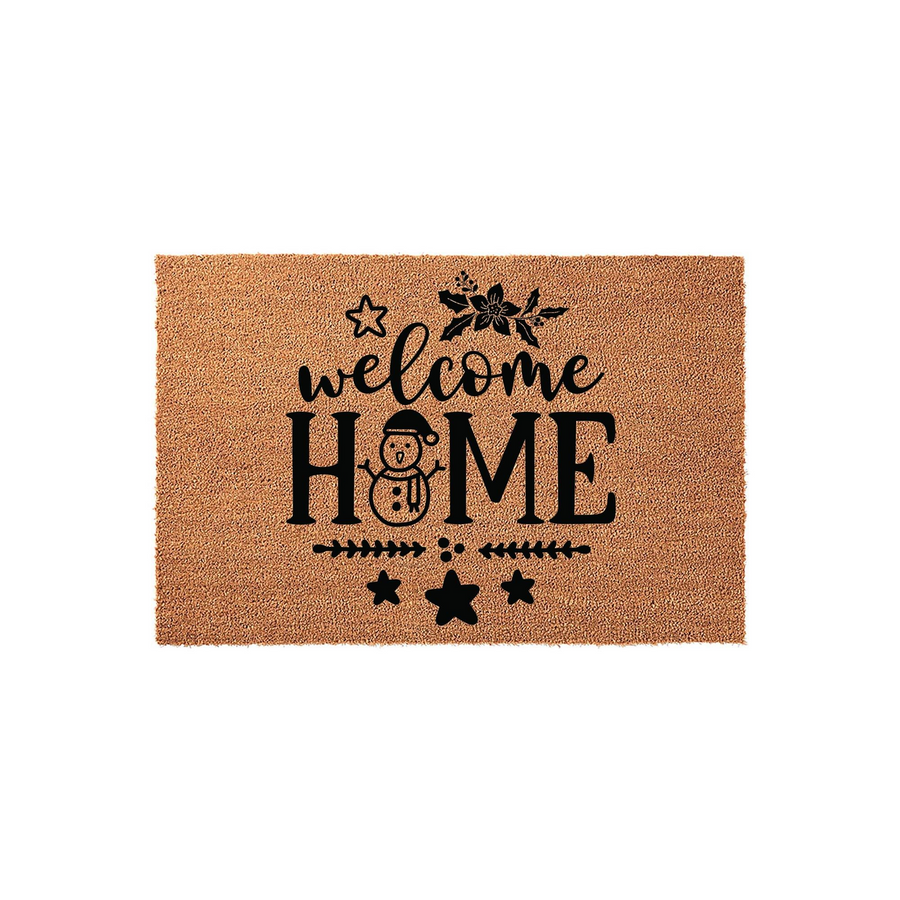 Christmas Welcome Home coir doormat featuring a black printed design with a cute snowman replacing the letter O, festive holly leaves, and stars on a natural tan textured fiber background for a cozy holiday entryway decoration.
