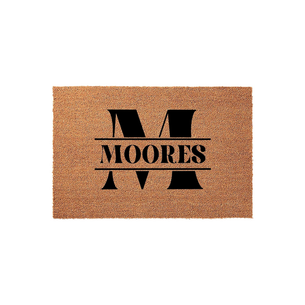 Personalized coir doormat featuring a large black split letter monogram design with a family name printed in the center, set against a natural tan textured fiber background for a classic and welcoming front porch entryway decor