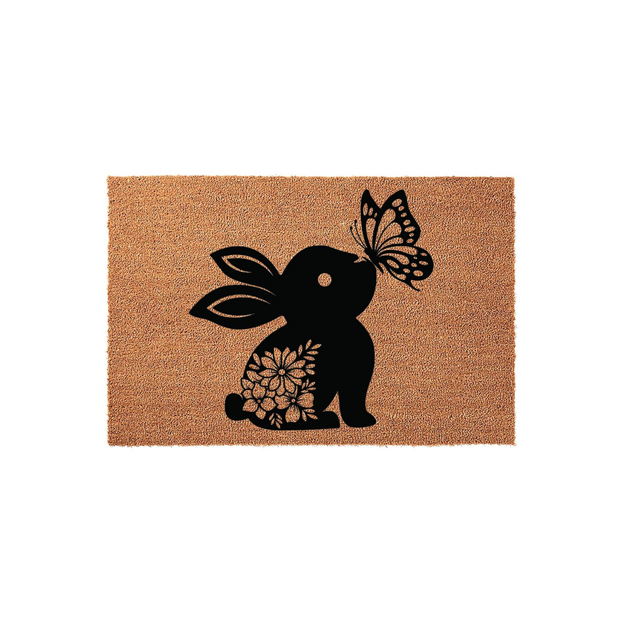Floral Bunny Rabbit Coir Doormat featuring a black silhouette of a bunny with a flower pattern on its body and a butterfly on its nose, set against a natural brown textured coir background for a charming spring or Easter home