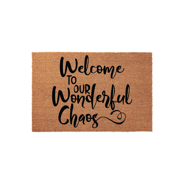 Welcome to Our Wonderful Chaos coir doormat featuring natural brown coconut fibers and bold black script lettering, providing a humorous and inviting entrance decor piece for your front porch or home entryway on a plain white