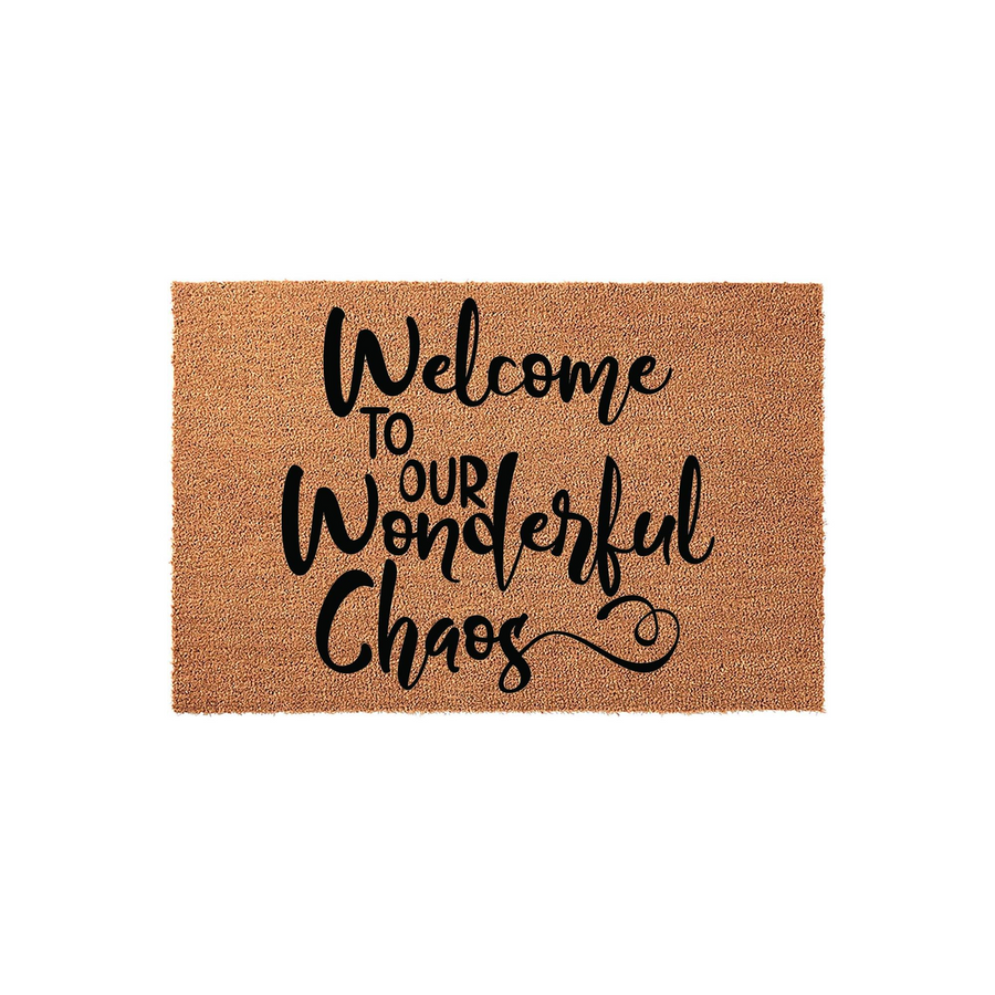 Welcome to Our Wonderful Chaos coir doormat featuring natural brown coconut fibers and bold black script lettering, providing a humorous and inviting entrance decor piece for your front porch or home entryway on a plain white