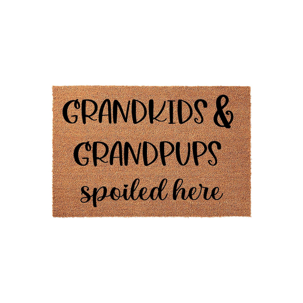 Grandkids and Grandpups Spoiled Here coir doormat featuring bold black lettering on a natural tan fiber background, creating a fun and welcoming entryway decor piece for a grandparent who loves their family and their pets.