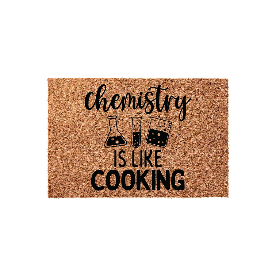 Chemistry Is Like Cooking doormat made of natural coir fiber, featuring a humorous science-themed design with black text and laboratory glassware illustrations printed on a textured, rectangular brown background for a fun home