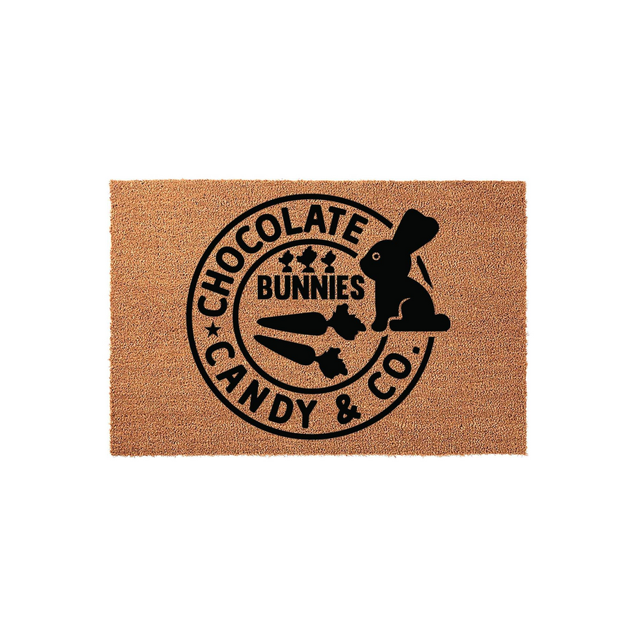 Chocolate Bunnies Candy and Co. Easter doormat featuring a natural coir fiber texture with a black circular logo design that includes a silhouette of a bunny and carrots, perfect for seasonal spring home decor on a front porch