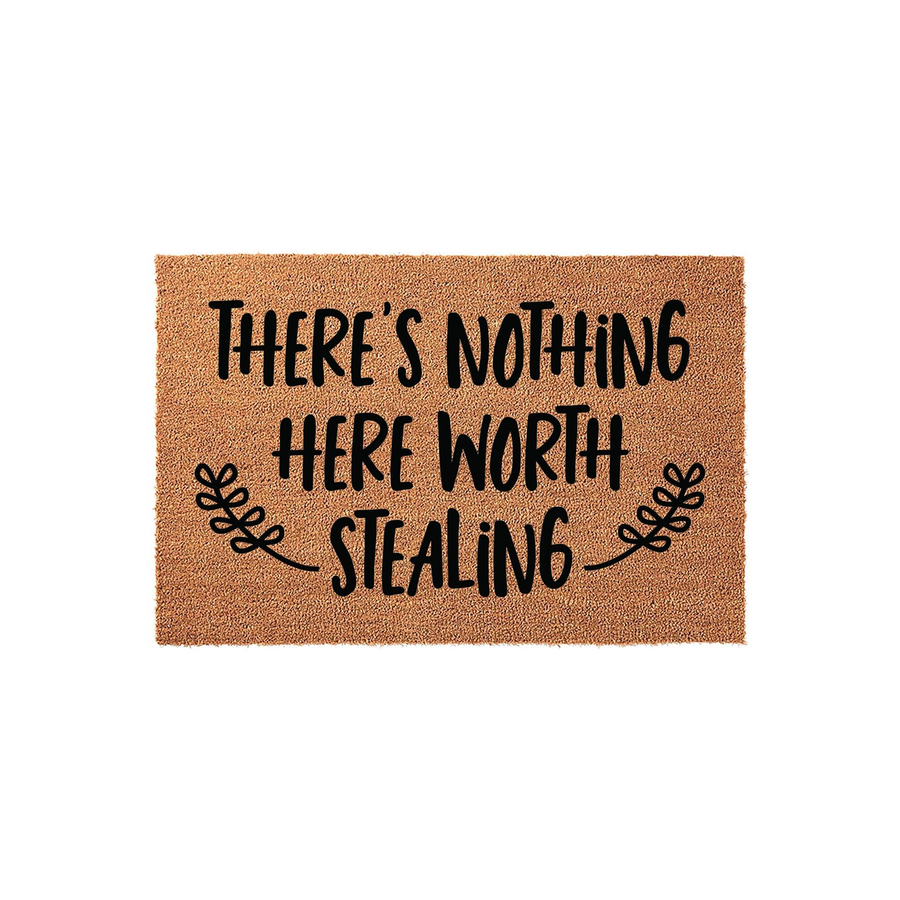 Funny There Is Nothing Here Worth Stealing doormat featuring bold black typography on a natural tan coir fiber background, accented with decorative leaf flourishes on either side of the text for a humorous front porch welcome.