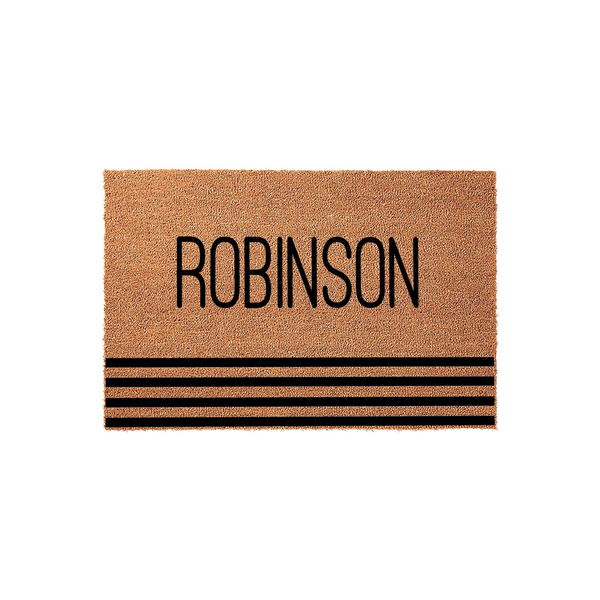 Personalized family name coir doormat featuring a natural tan fiber texture with bold black lettering and three horizontal stripes at the bottom, creating a modern and welcoming entrance decor piece for any front porch or home