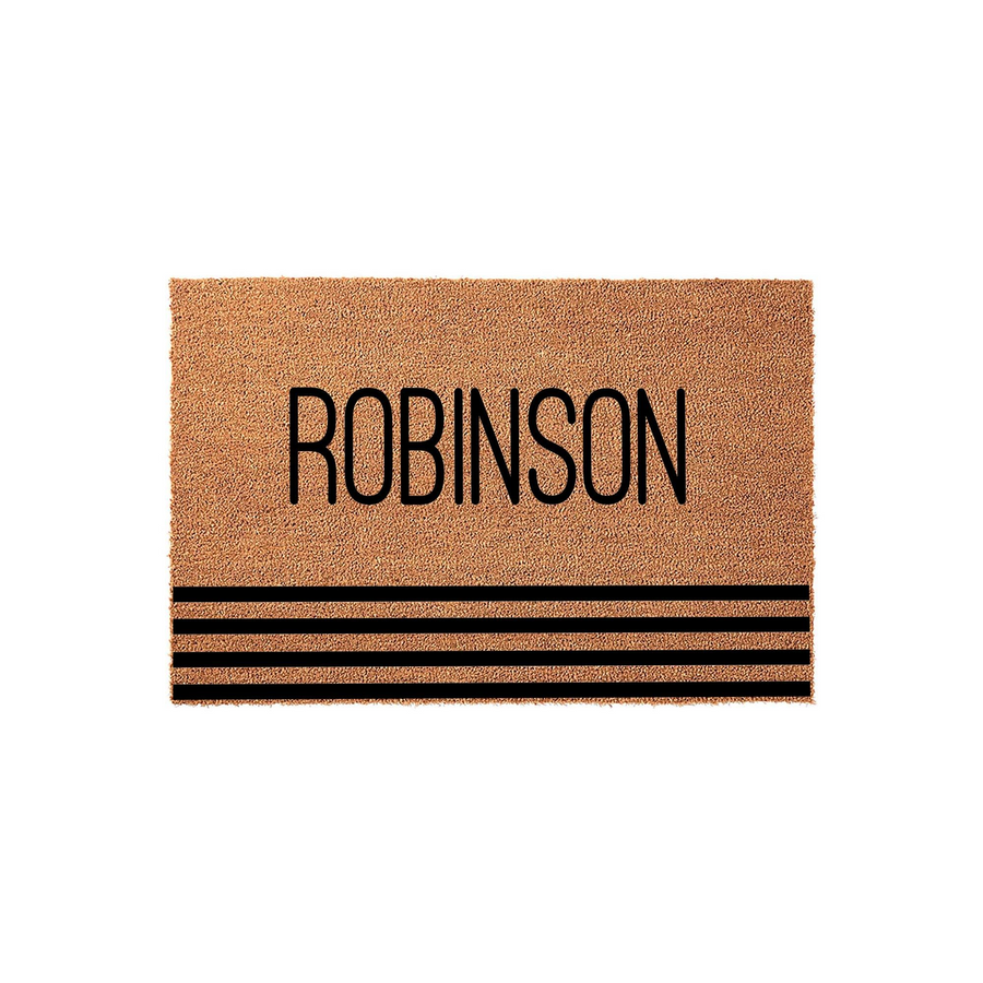 Personalized family name coir doormat featuring a natural tan fiber texture with bold black lettering and three horizontal stripes at the bottom, creating a modern and welcoming entrance decor piece for any front porch or home