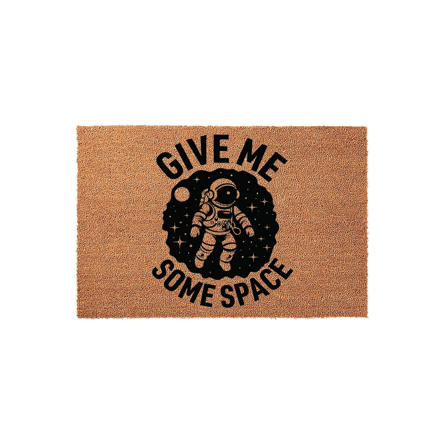 Astronaut Give Me Some Space doormat featuring a natural coir texture with a black printed graphic of an astronaut floating in a starry galaxy, creating a fun and whimsical welcome mat for any space enthusiast or science lover