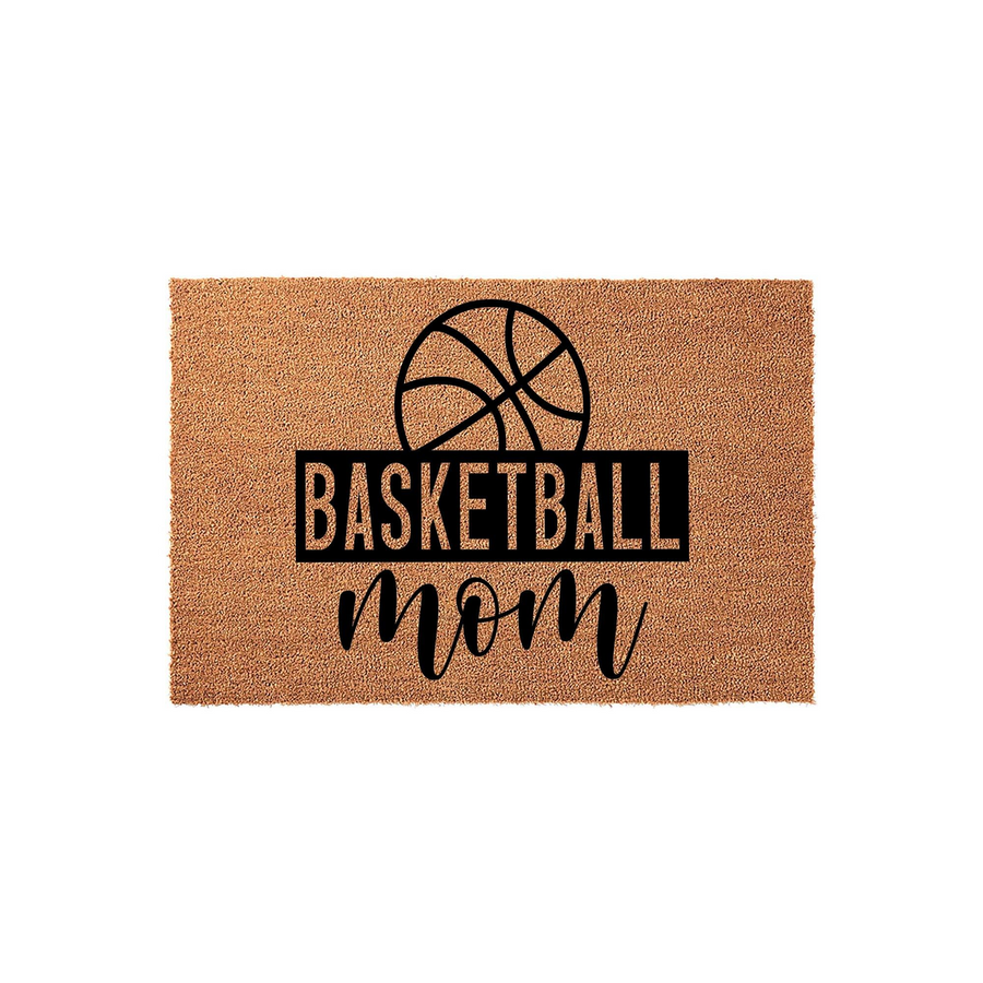 Basketball Mom coir doormat featuring a bold black graphic of a basketball above the text Basketball Mom in a mix of block and script fonts, set against a natural tan textured fiber background for a sporty home entryway decor.