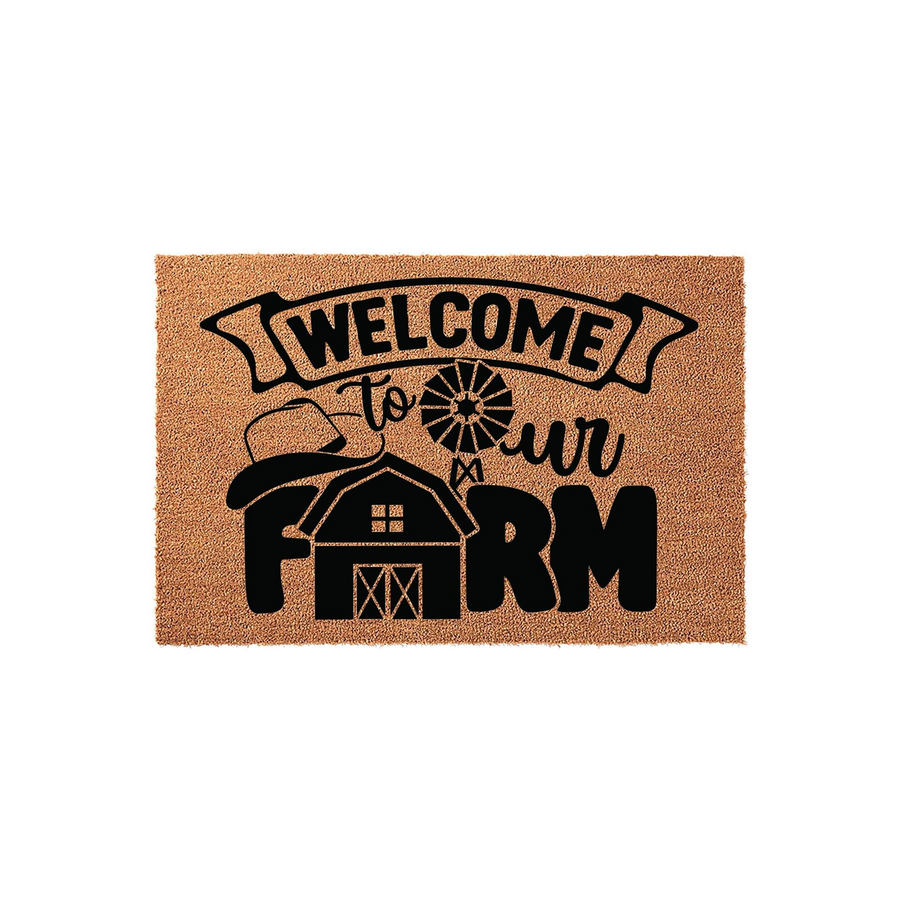 Farmhouse Welcome To Our Farm doormat featuring a rustic barn, windmill, and cowboy hat graphic printed in black on a natural coir fiber mat, creating a charming entryway accent for any country home or farmhouse style front porch