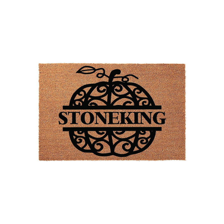 Personalized Pumpkin Fall Doormat featuring a decorative black scrollwork pumpkin design on a natural coir fiber mat, with a central horizontal bar for a custom family name to welcome guests to your home during the autumn season.