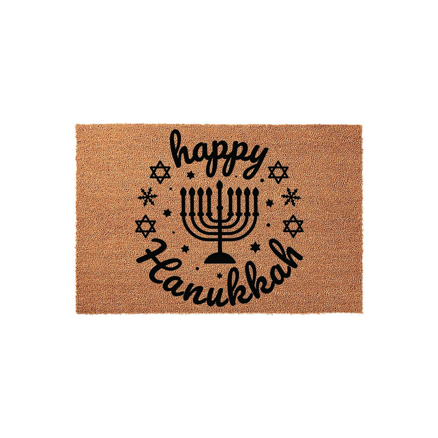 Happy Hanukkah coir doormat featuring a black printed menorah design surrounded by a circular wreath of Stars of David and snowflakes, set against a natural tan fiber background for a festive holiday entryway decoration.
