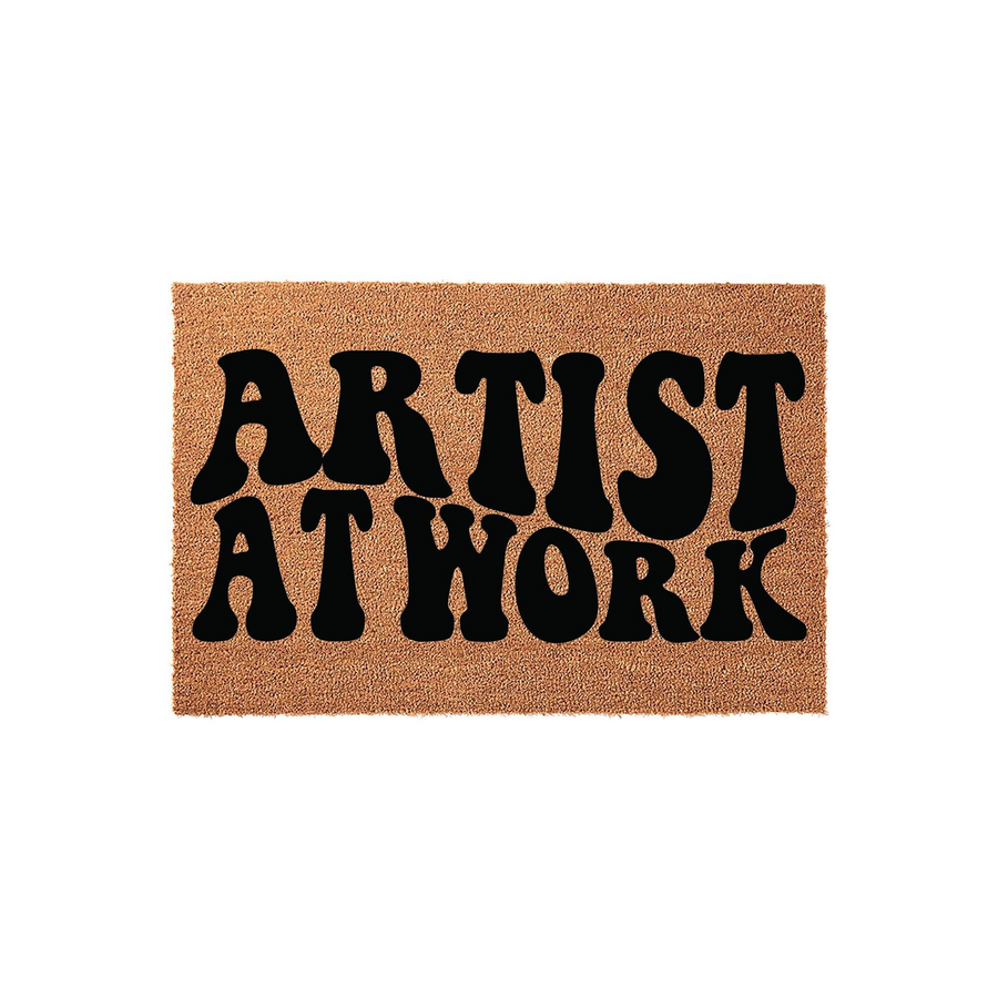 Artist at Work coir doormat featuring bold, retro-style black typography printed on a natural tan fiber background, creating a fun and creative entryway accent for any home studio or front porch area that welcomes guests with