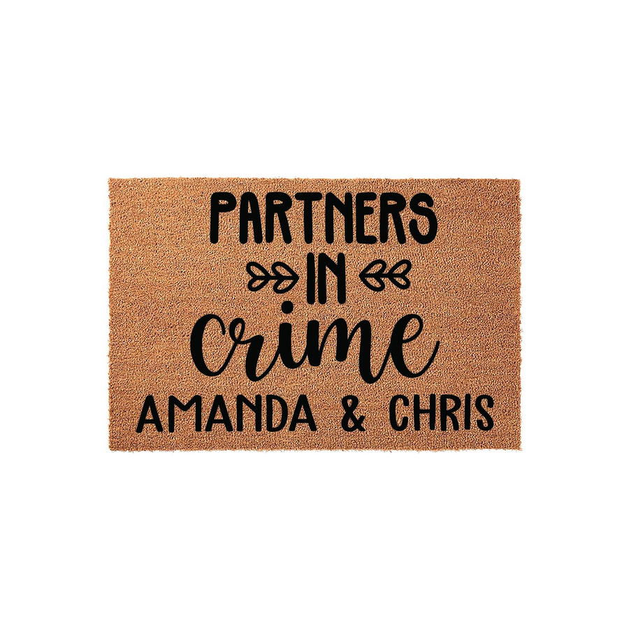 Personalized Partners in Crime coir doormat featuring a natural brown fiber texture with bold black text and decorative heart accents, providing a fun and welcoming entrance for any couple's home or apartment front door entryway.