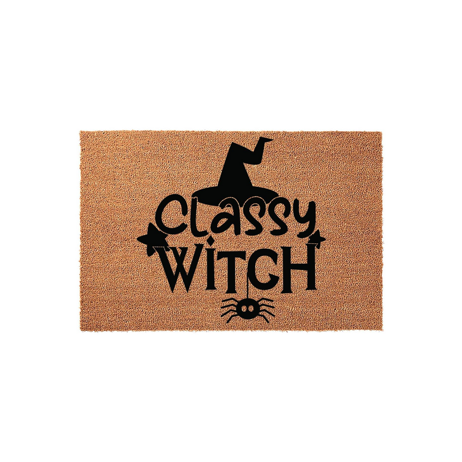 Classy Witch Halloween doormat made of natural coir fiber, featuring a black printed design of a witch hat, stars, and a hanging spider on a textured brown background for a festive seasonal entryway decoration.