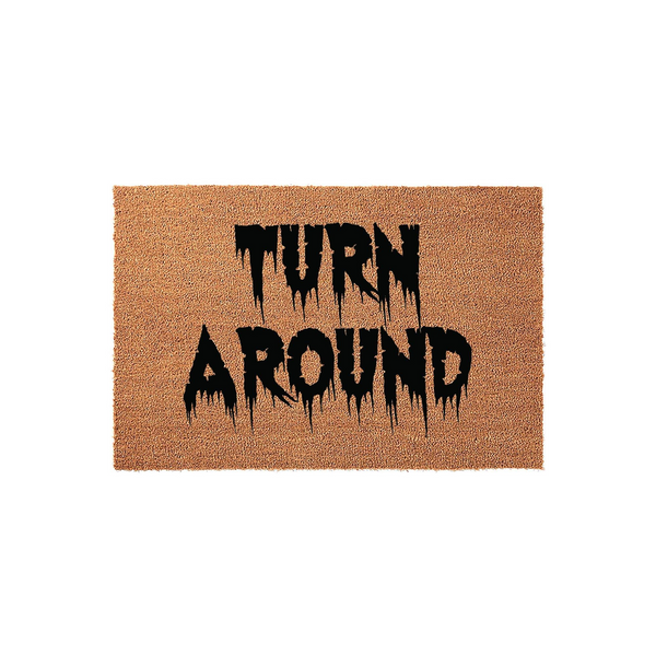 Spooky Halloween doormat featuring the text Turn Around in a dripping, horror-style black font on a natural tan coir background, creating a fun and festive entryway decoration for the fall season and October holiday home decor.