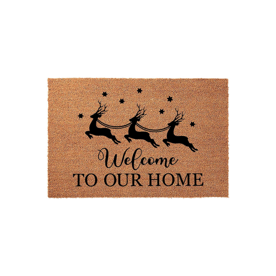 Christmas Reindeer Welcome Doormat featuring a natural coir texture with a black printed design of three flying reindeer pulling a sleigh, accented by stars and the text Welcome To Our Home on a clean white background.