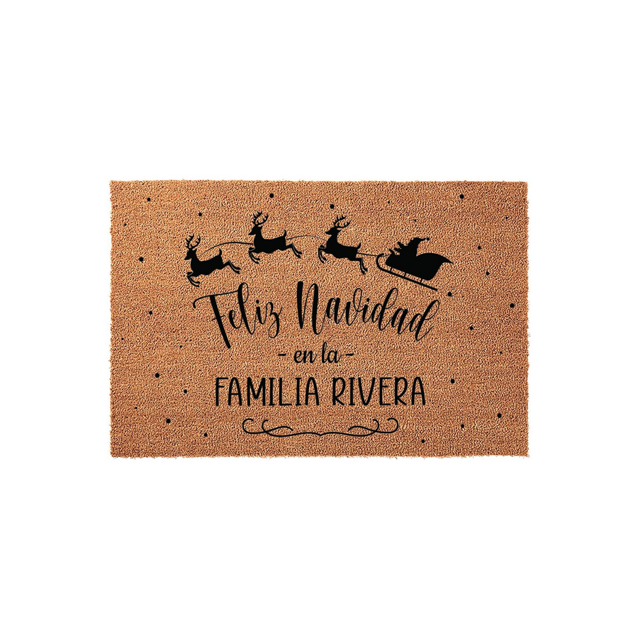 Personalized Feliz Navidad Christmas doormat featuring a black silhouette of Santa and his reindeer flying across a natural coir mat, accented with festive dots and space to add a custom family name for a holiday home entrance.